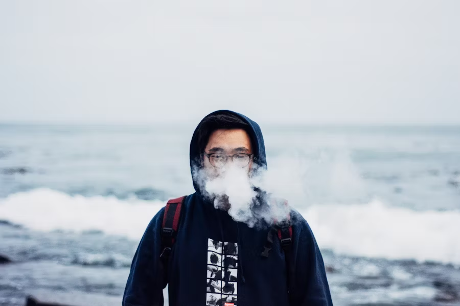 A Man Enjoying Nicotine-Free Vaping With A Juul Alternative