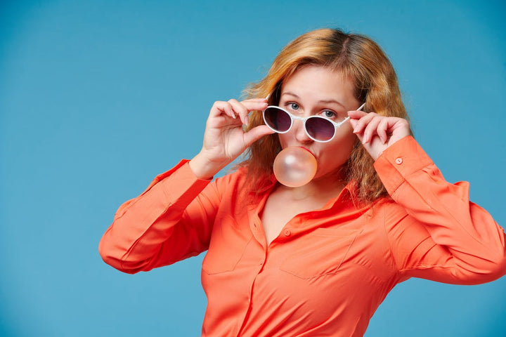 Model in Sunglasses Blowing Bubble Gum Balloon