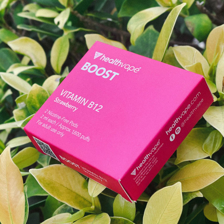 HealthVape BOOST Strawberry pod box close-up in outdoor garden setting