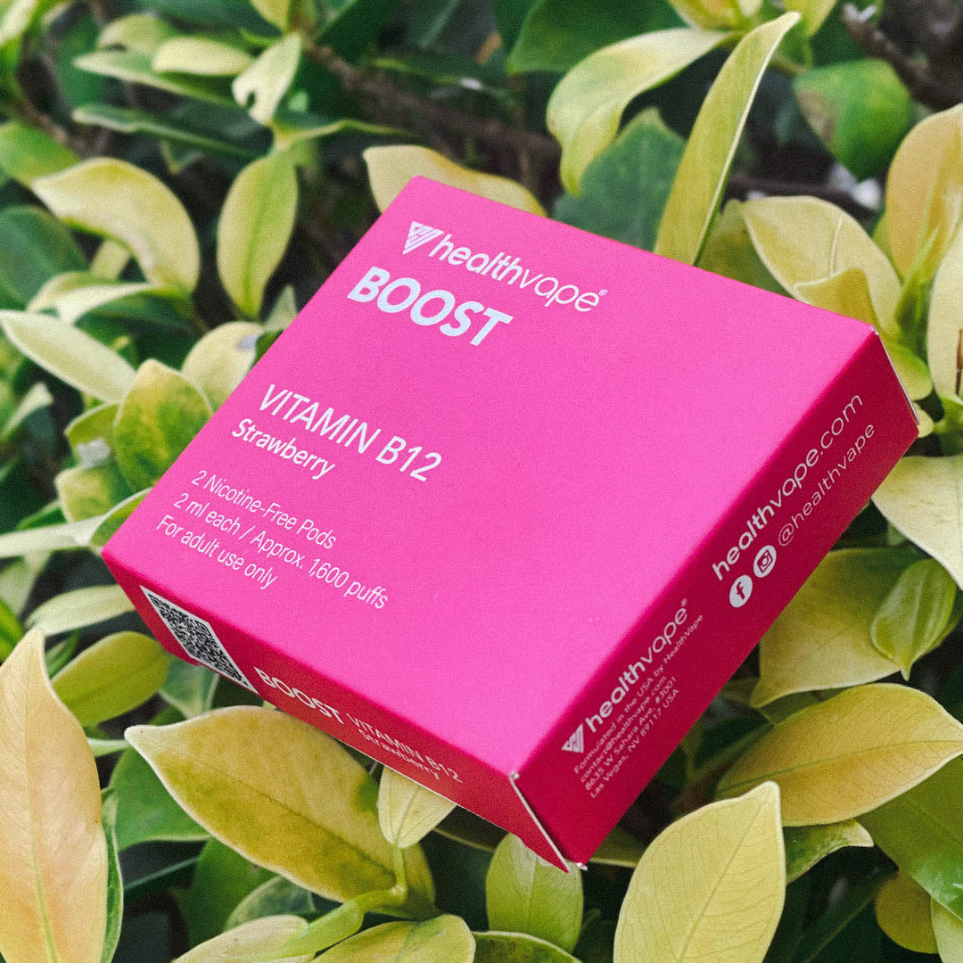 HealthVape BOOST Strawberry pod box close-up in outdoor garden setting